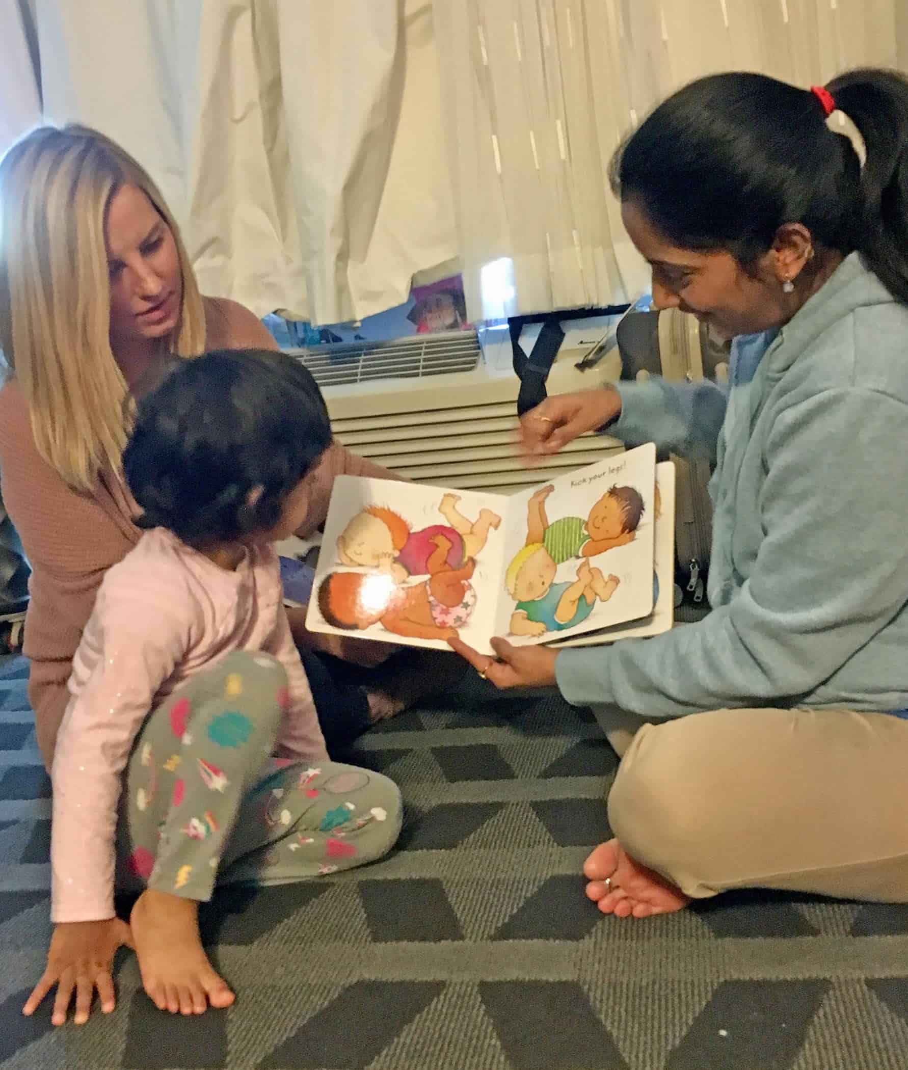 Katherine Quinn (left) a parent educator with the Springfield Parents as Teachers program, assists a family with early childhood educational development during a home visit in Greene County.