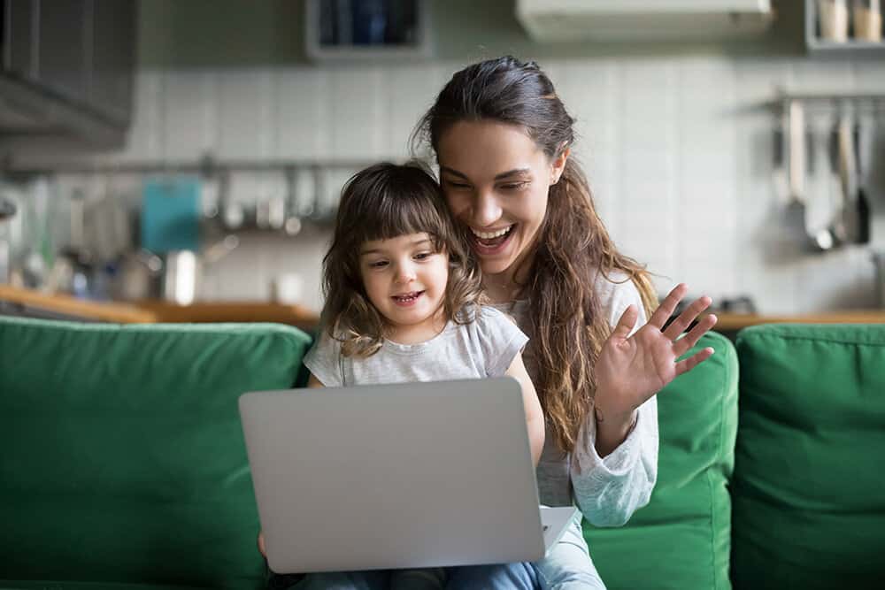 Mother and daughter speak to their parent educator during a virtual home visit.