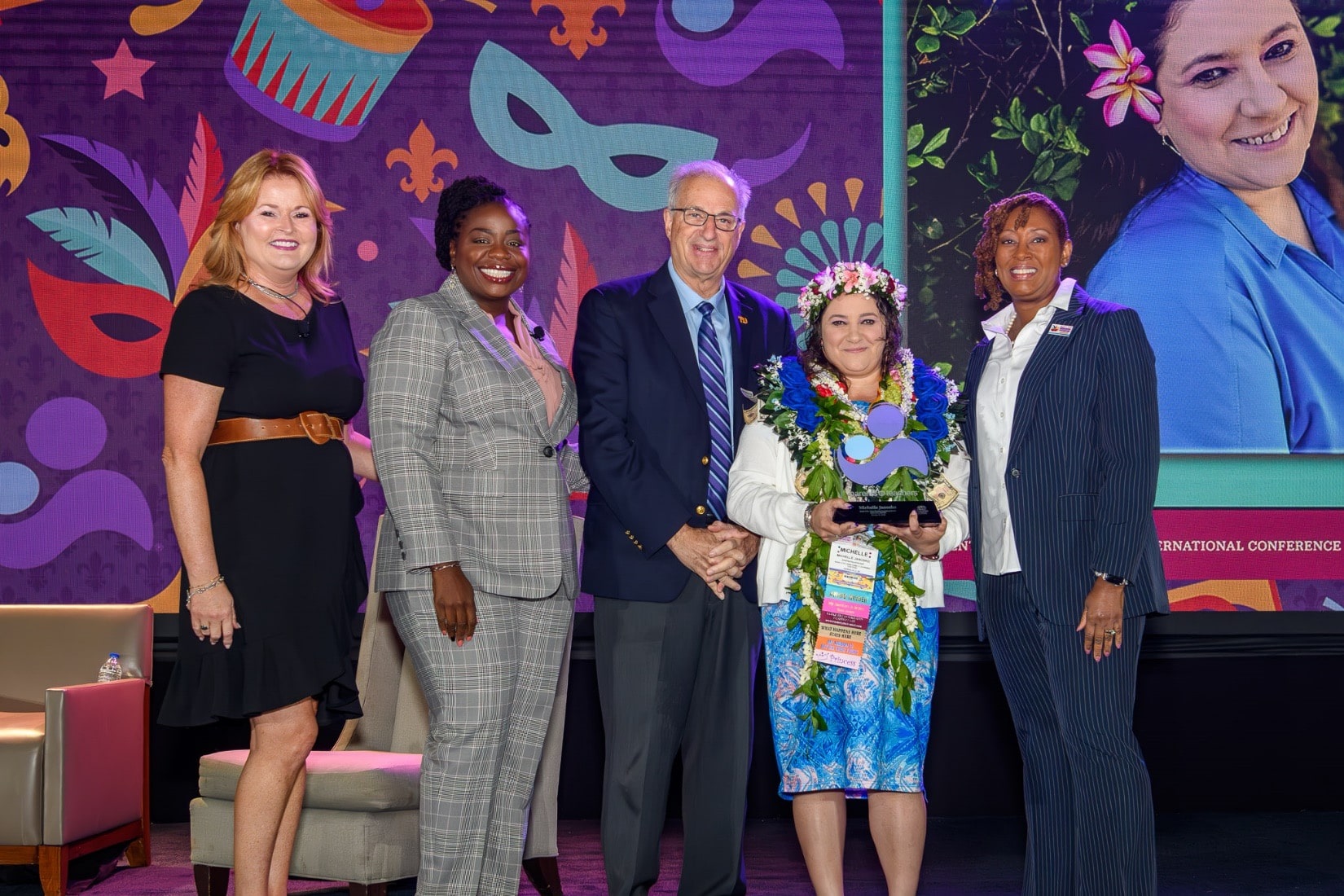 Michelle Janosko (second from right) receives her Parent Educator of the Year Award at the Parents as Teachers 2023 International Conference in New Orleans. From left are Parents as Teachers Board Members Suzy Gibson, Dr. Jamie Singleton, Board Chair Dr. Mark Ginsberg and President/CEO Constance Gully.